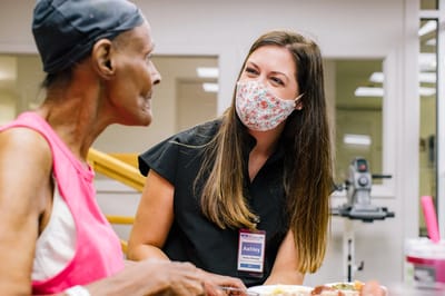 Staff member engaging with a resident during meal time