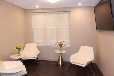 Bright seating area with flowers and modern chairs