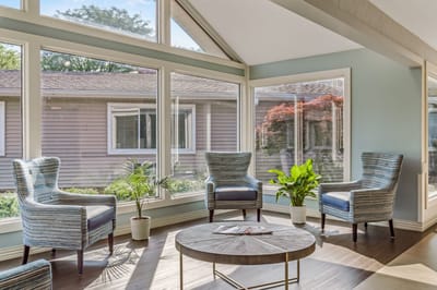Bright common area with large windows and seating