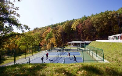 Residents enjoying tennis on a sunny day