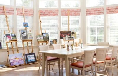 Art activity room with various paintings displayed