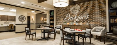 Common area with tables and a brick wall decor