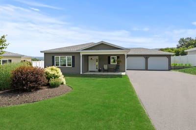Exterior view of a facility building with lawn and walkway