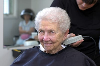 Senior resident getting a haircut in the salon