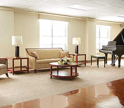 Interior common area with seating and a piano