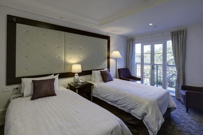 Brightly lit private resident room with two beds