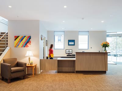 Bright reception area with staff member walking by