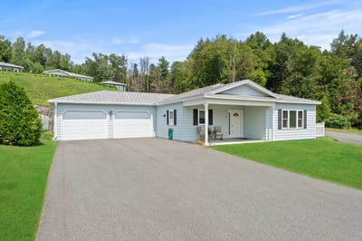 Exterior view of a residential-style facility with green lawn