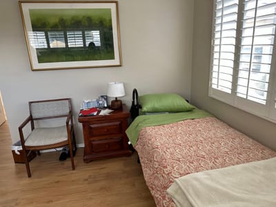 Cozy resident room with bed and chair