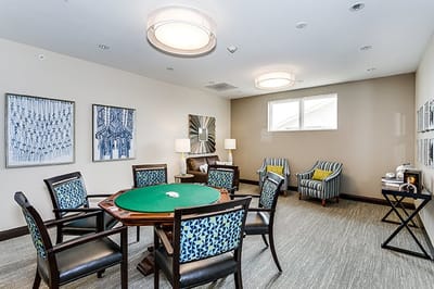 Bright common area with seating and a green table