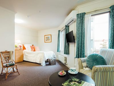 Cozy resident room with a bed and seating area