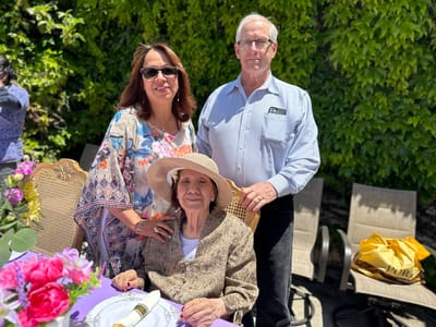 Family celebrating outdoors with a resident