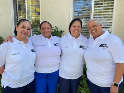 Staff members posing together outside the facility