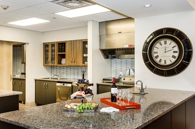 Interior view of a modern kitchen with food and wine