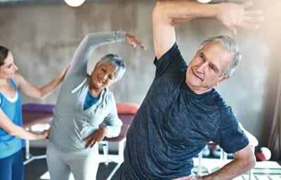 Residents participating in a stretching exercise class