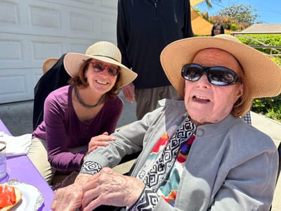 Resident and staff enjoying outdoor meal together