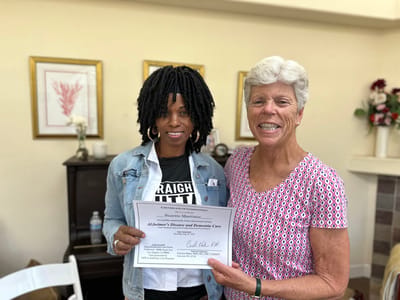 Staff member presenting a certificate to a resident