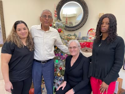 Residents and staff celebrating in a decorated common area