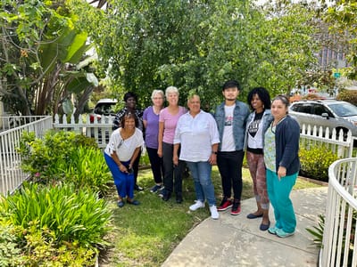 Staff and residents gathered in a garden area
