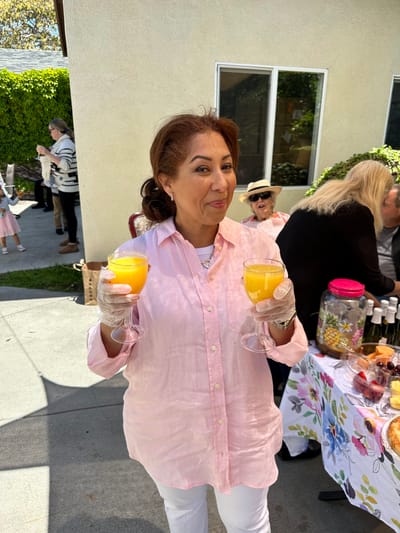 A staff member serving drinks at an outdoor event