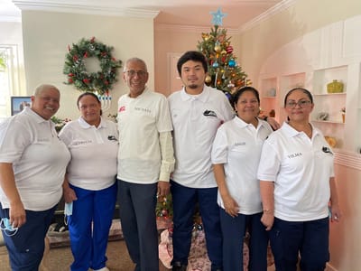 Staff members posing together in a common area during the holidays