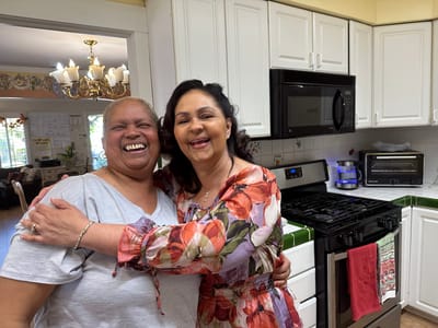 Two smiling residents in a bright kitchen