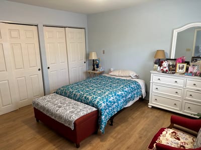 Cozy bedroom with a bed and dresser
