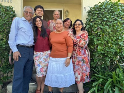 Residents and staff posing together at the entrance
