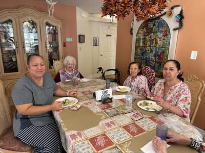 Residents enjoying a meal at a dining table