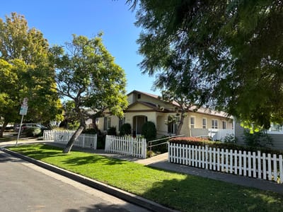 Exterior view of a residential care facility with gardens