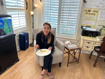 A female staff member enjoying a meal in a cozy common area