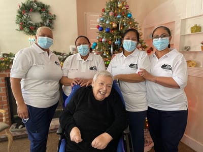 Staff and resident celebrating in a decorated common space
