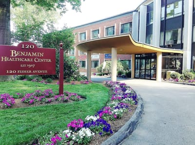 Exterior view of the Benjamin Healthcare Center with flowers