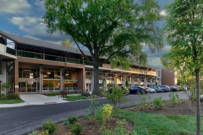 Exterior view of a senior living facility with landscaped grounds