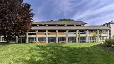 Exterior view of Cathedral Village building with landscaping