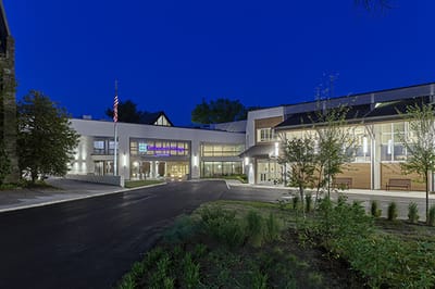 Exterior view of Cathedral Village at dusk