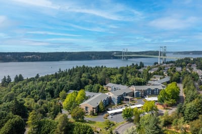 Aerial view of assisted living facility near a bridge and waterfront