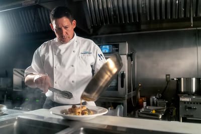 Chef preparing a gourmet meal in a kitchen