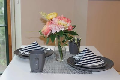 Table setting with flowers and plates in a dining area