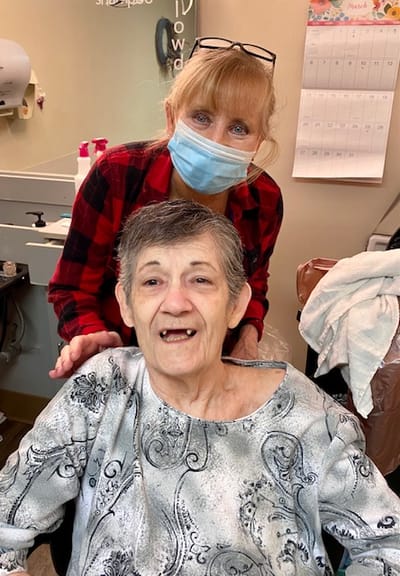 Care staff assisting a resident in a facility