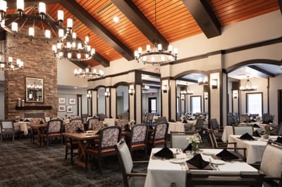 Elegant dining room with wooden beams and chandeliers