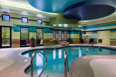 Indoor pool area with vibrant wall colors