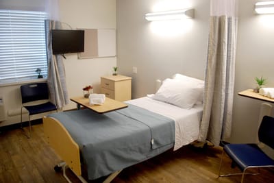 Bright private room with adjustable bed and seating