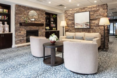 Cozy common area with seating and bookshelf