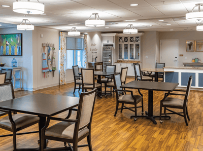 Bright and spacious common area with dining tables