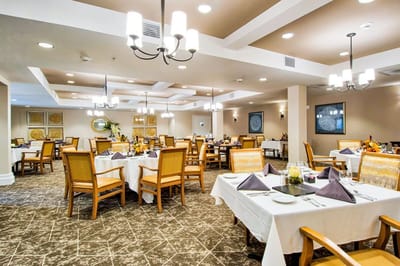 Interior view of a dining room with tables set for a meal