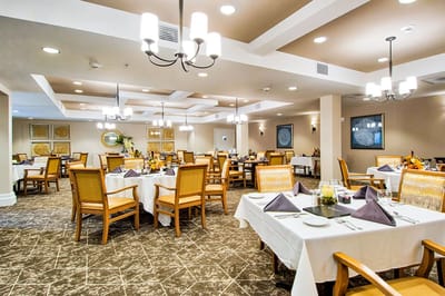 Dining room with tables set for residents