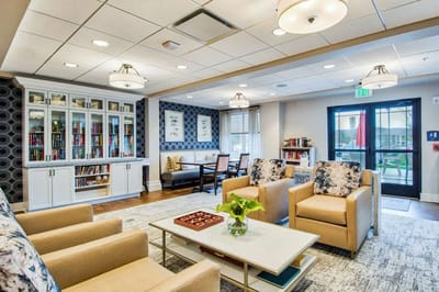 Bright common area with comfortable seating and bookshelves