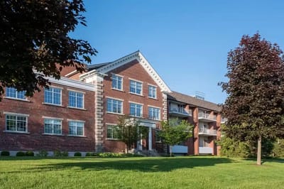 Exterior view of a senior living facility with landscaped grounds
