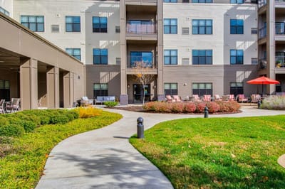 Outdoor pathway leading to the facility with gardens